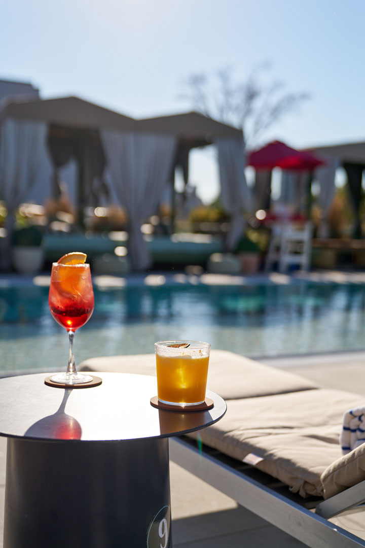 news33al Elegant restaurant interior featuring plush seating, golden wall art, and large windows inviting natural light.